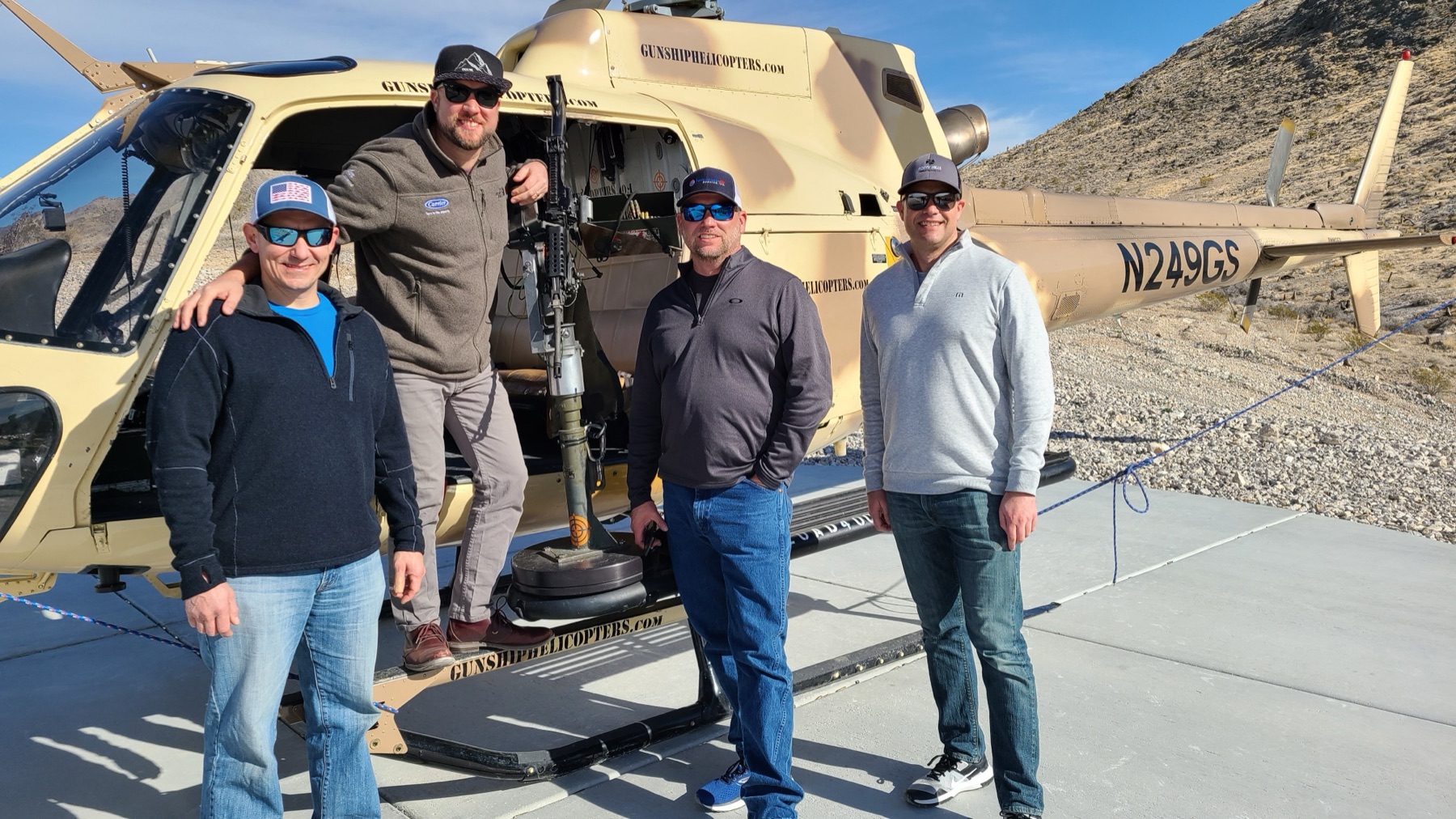 Nathan Mark with clients in front of a helicopter